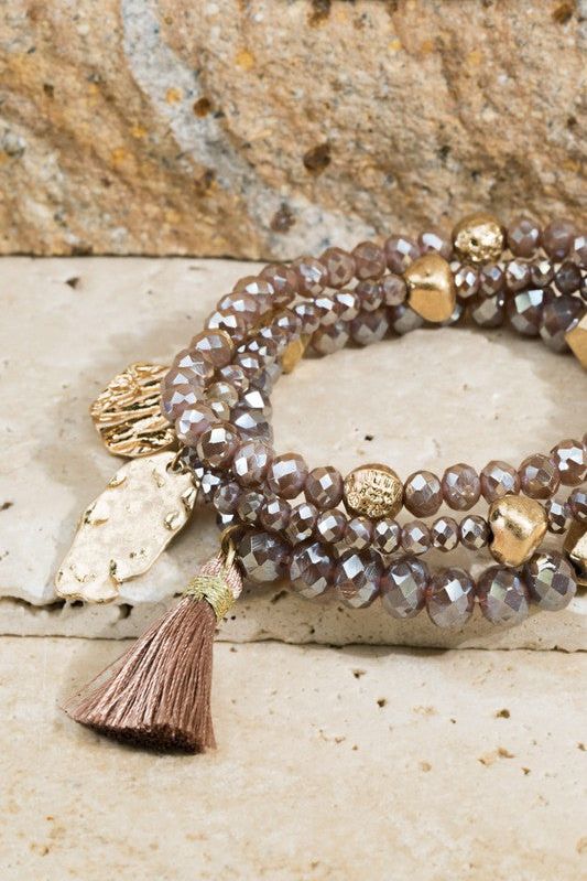 Shimmering glass beaded bracelet set with charms