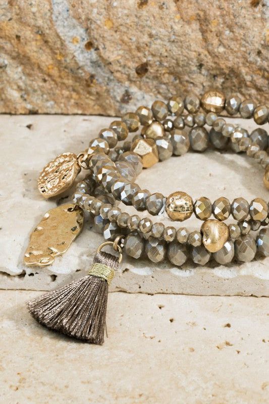 Shimmering glass beaded bracelet set with charms